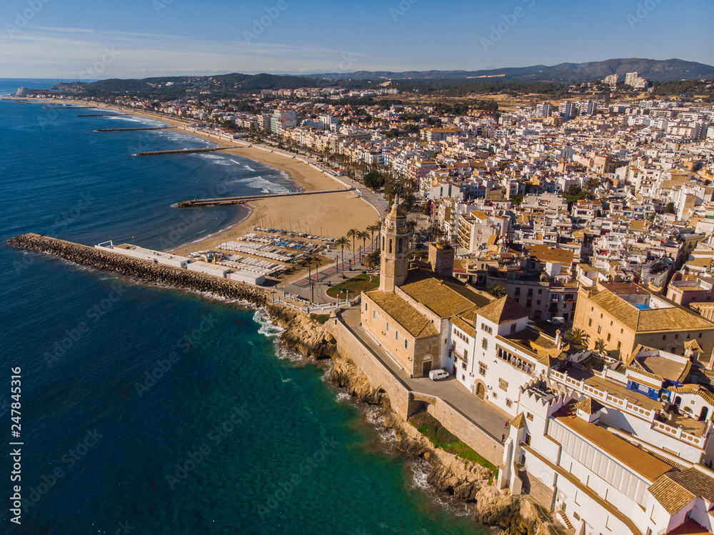 Fototapeta premium Sitges city view from a drone with the port and the beach of catalunia in a holiday village