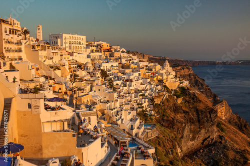 Greece - Santorini island - Beautiful panoramic view of fabulous Thira town with traditional white houses picturesque located on the Aegean sea coast along the edge of an ancient volcano at sunset