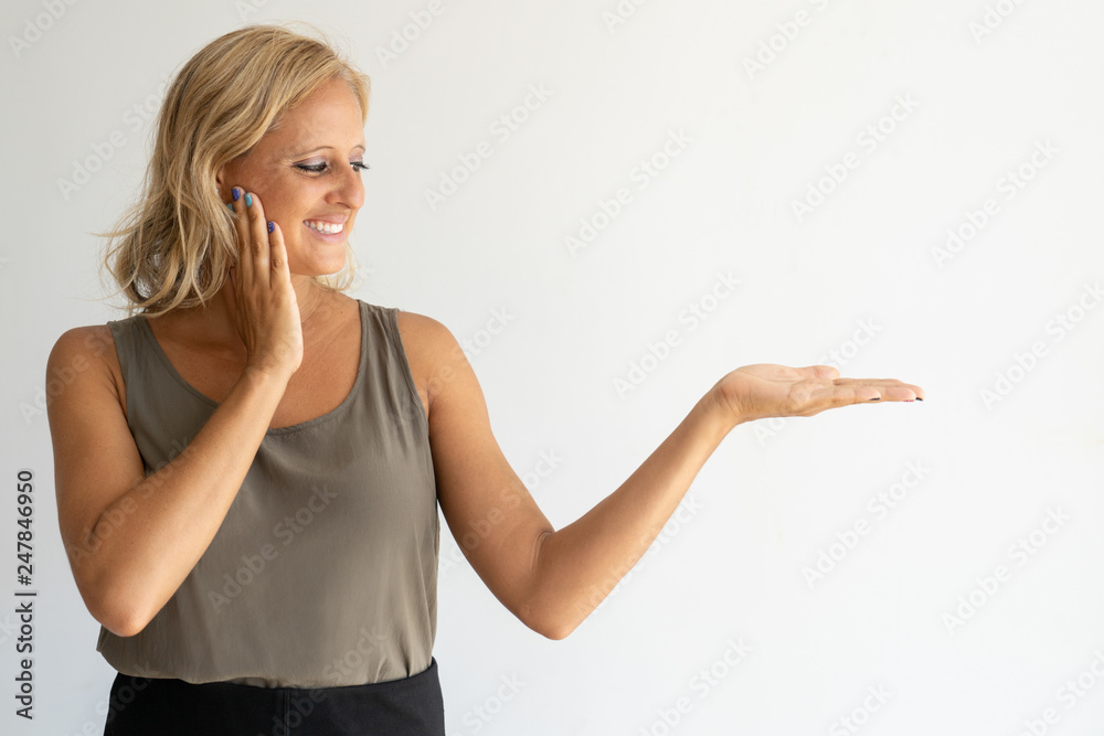 Woman looking at invisible product in her hand Woman looking at invisible product in her hand