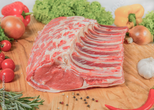 Juicy raw meat, beef entrecote on black background, top view photo