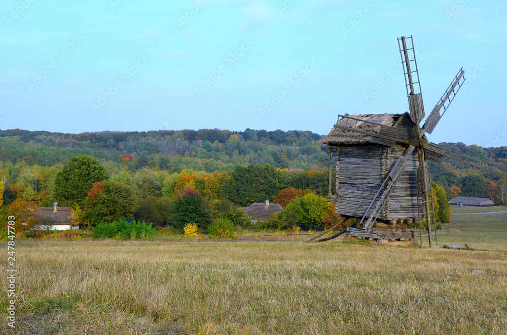 Countryside with old wooden huts and windmills