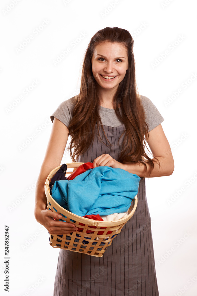 woman doing a housework holding laundry isolated over white background
