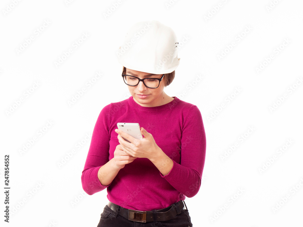 Emotional girl brigadier in a white helmet with glasses and a folder in his hands on a white background