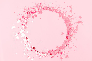 Festive pink background. Shining stars on light pink pastel background. Christmas. Wedding. Birthday. Happy woman's day. Mothers Day. Valentine's Day. Flat lay, top view, copy space