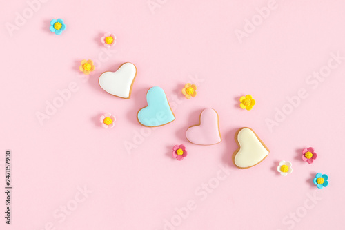 Composition Valentine's Day. Valentine cookies in shape heart on pastel pink background. Flat lay, top view, copy space