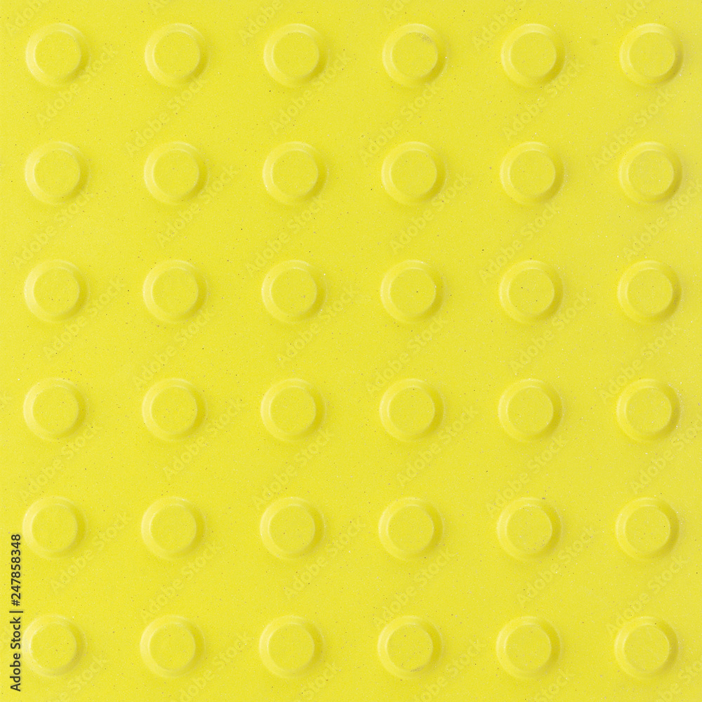 Yellow ceramic tile with rough surface and simple pattern. Yellow texture background. Yellow ceramic tile with rough surface and simple pattern. Yellow texture background.