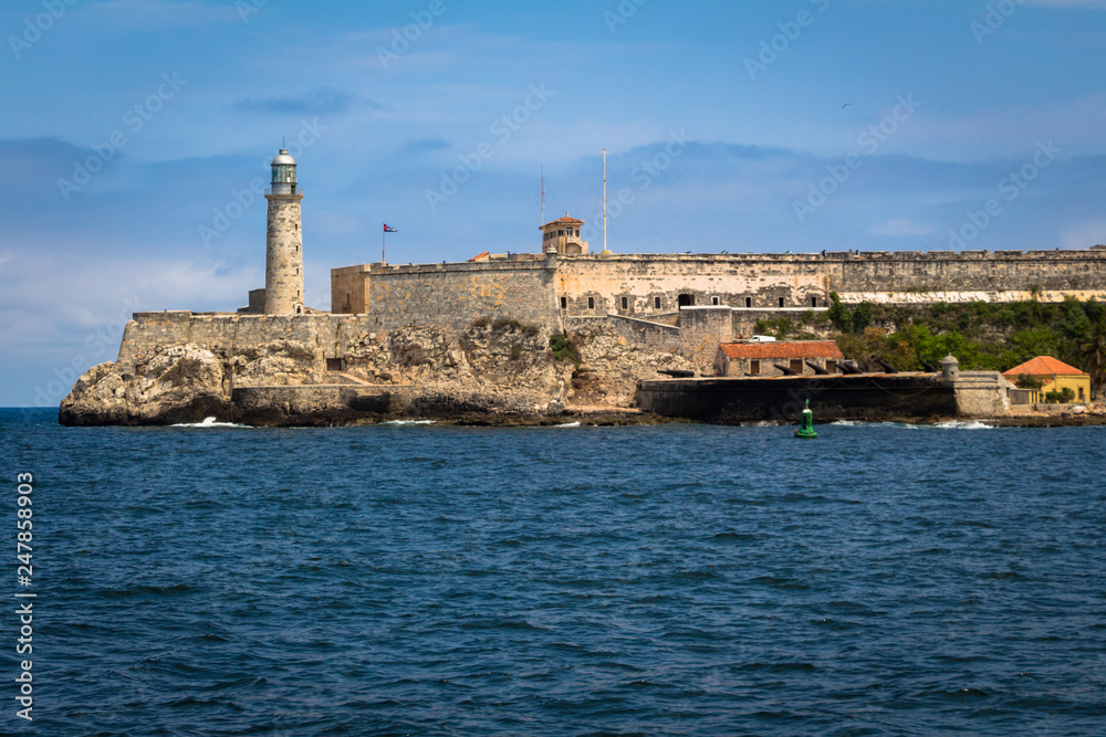 View over Morro Castle, fortress and a lighthouse in Havana, Cuba. Blue water and blue clear sky.