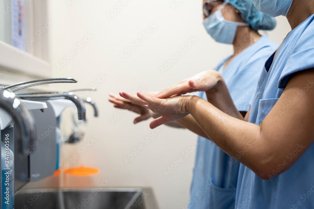 Foto de Two female surgeon doctors wash their hands before the