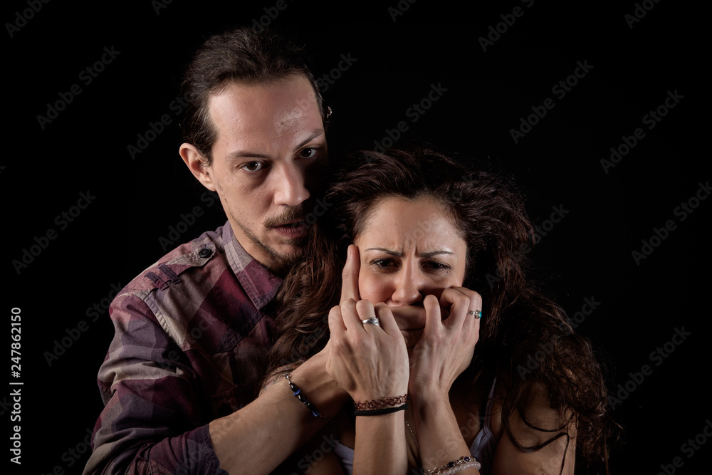 man threatening a scared woman in a gender violence case between a young couple arguing and struggling man threatening a scared woman in a gender violence case between a young couple arguing and struggling