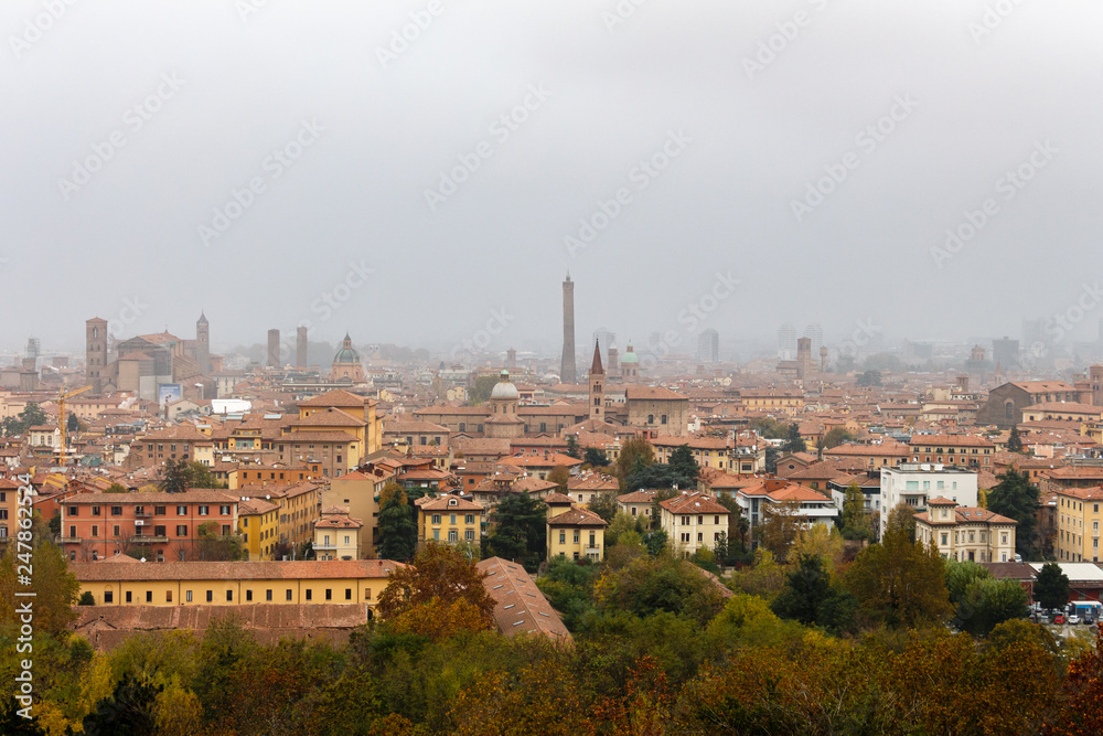 Bologna, Italy panorama view from San Michele in Bosco viewpoint. Foggy fall day. Cityscape.
