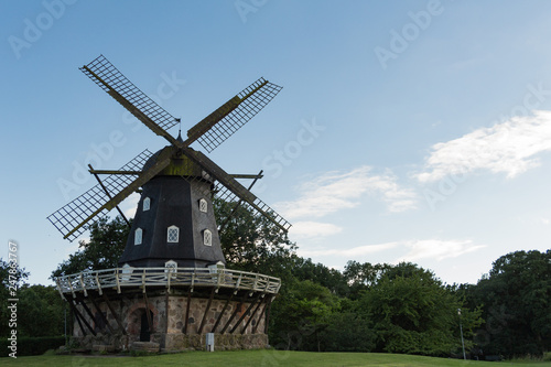 Traditional wooden windmill in one of the parks in Malmö, Sweden on a sunny summer day.