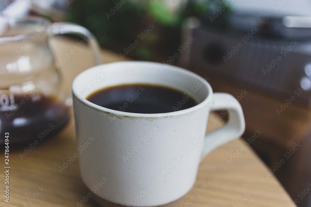White cup of coffee on wooden table White cup of coffee on wooden table