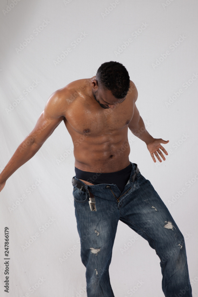 Handsome, shirtless black man looking down Handsome, shirtless black man looking down