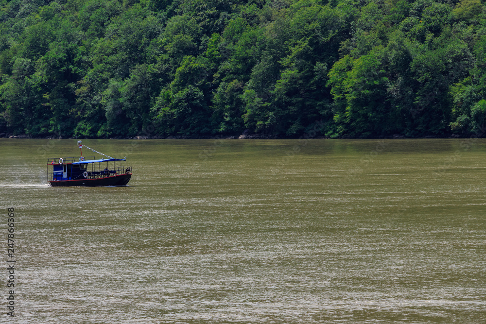 Small tourist boat cruising on the Danube river in Djerdap gorge national park, Serbia. Small tourist boat cruising on the Danube river in Djerdap gorge national park, Serbia.