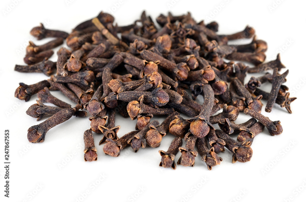 Spice cloves. Carnation. The buds fragrant cloves on a white background, isolated. Shallow depth of field, closeup. Spice cloves. Carnation. The buds fragrant cloves on a white background, isolated. Shallow depth of field, closeup.