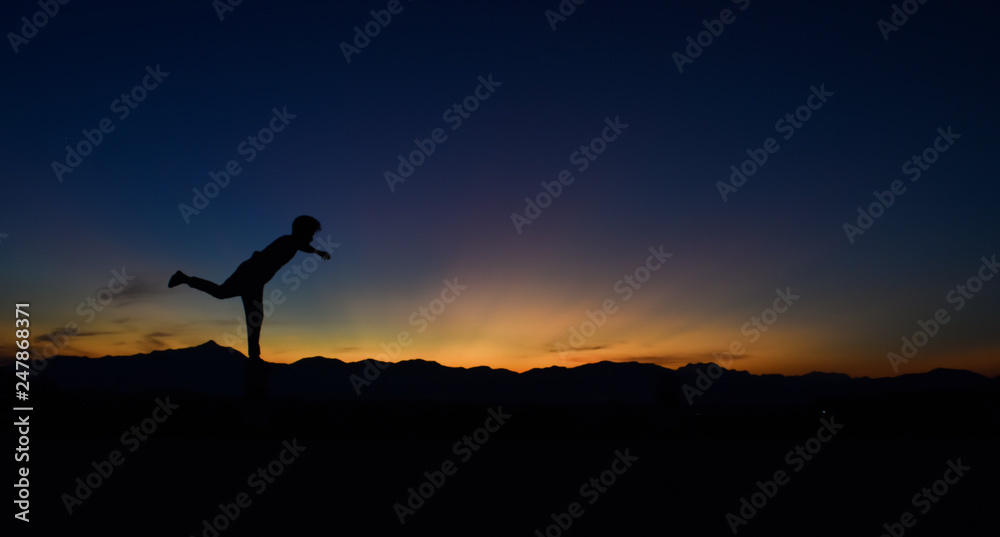 Silhouette of man doing walking at sunset, Concept lifestyle freedom vacation travel.