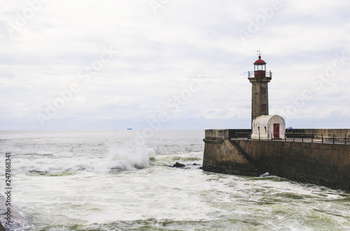Old stone lighthouse and ocean view in Porto