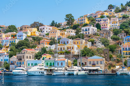 Sail boats, yachts and colorful houses in harbor town of Symi (Symi Island, Greece) © lubos K