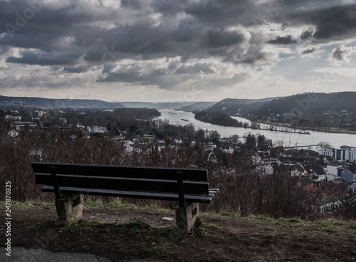 a bench sitting overlooking the river rhin in bonn,germany