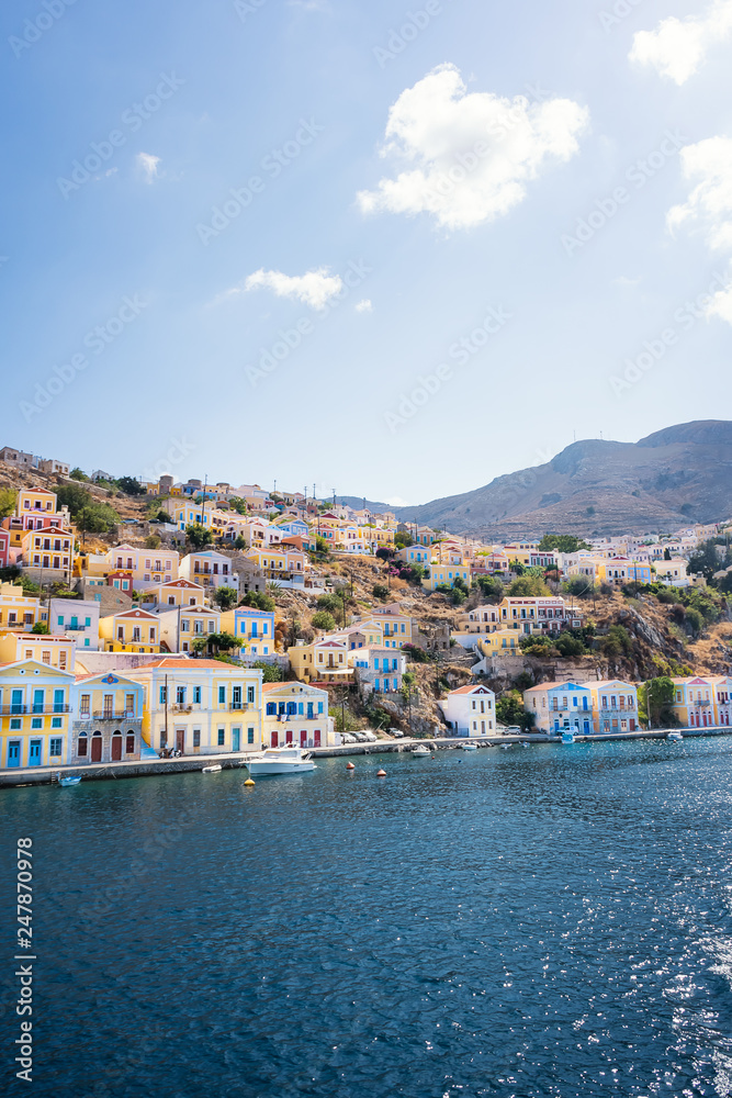 Colorful neoclassical houses in harbor town of Symi (Symi Island, Greece)