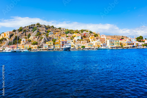 Colorful neoclassical houses in harbor town of Symi (Symi Island, Greece)