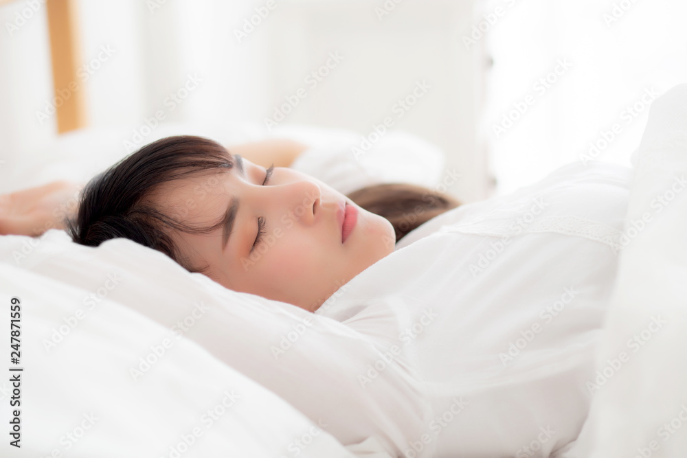 Beautiful asian young woman sleeping lying in bed with head on pillow comfortable and happy. girl with relax for health concept.