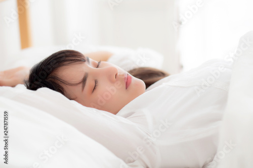 Beautiful asian young woman sleeping lying in bed with head on pillow comfortable and happy. girl with relax for health concept.