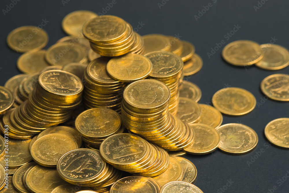 Savings, increasing columns of coins, piles of coins arranged as a graph in dark room, business banking concept. Savings, increasing columns of coins, piles of coins arranged as a graph in dark room, business banking concept.
