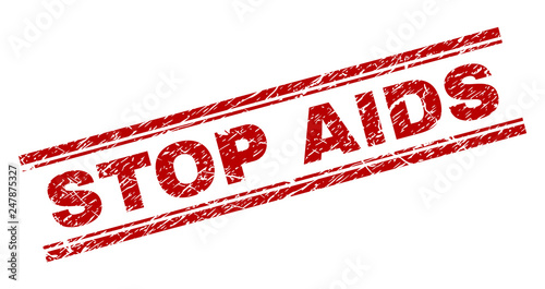 STOP AIDS seal stamp with corroded texture. Red vector rubber print of STOP AIDS text with unclean texture. Text title is placed between double parallel lines.