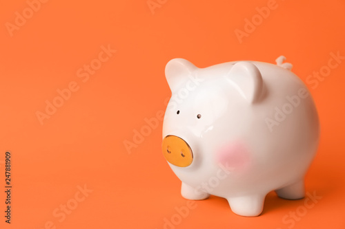 White piggy bank on color background. Money saving