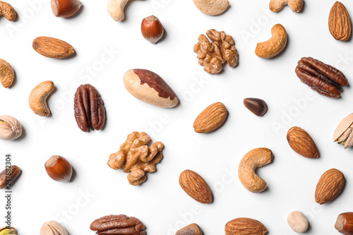 Composition with organic mixed nuts on white background, top view