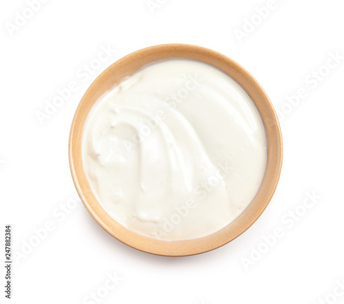 Bowl with creamy yogurt on white background, top view