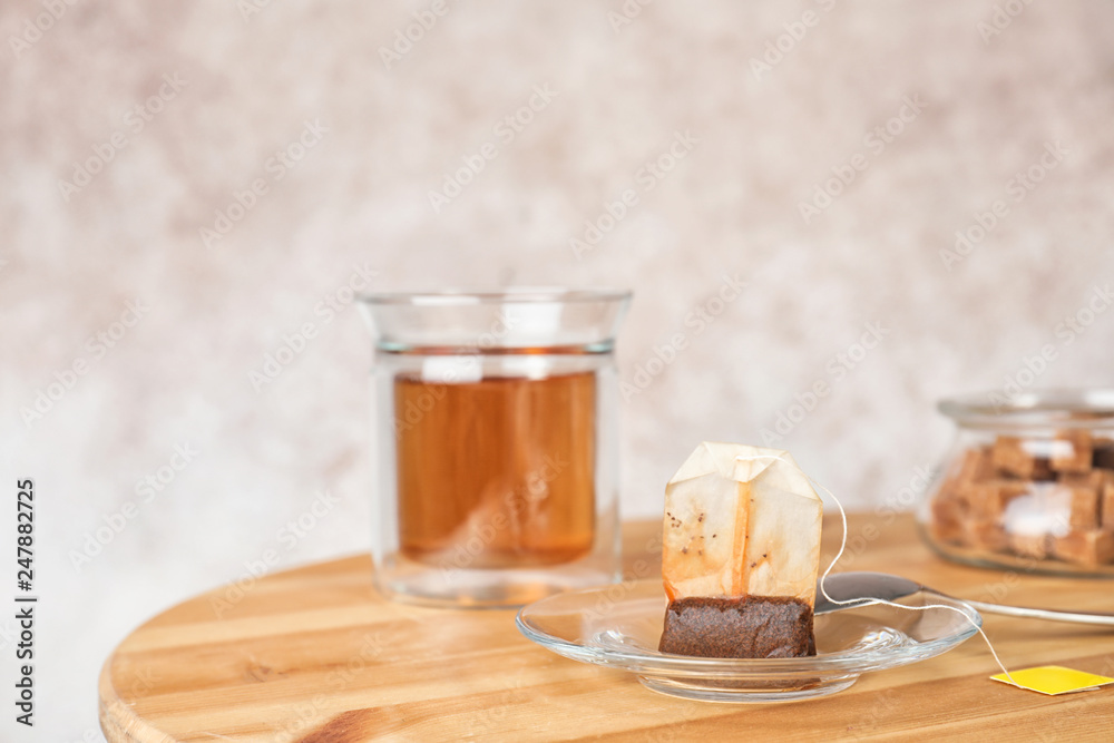 Saucer, spoon with used teabag and cup on table. Space for text Saucer, spoon with used teabag and cup on table. Space for text