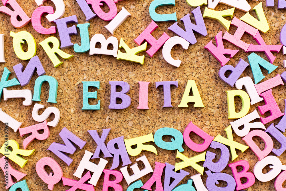 Color alphabet in word EBITA (abbreviation of earnings before interest,  taxes and amortization) with another letter as frame on cork board  background Stock-Foto | Adobe Stock