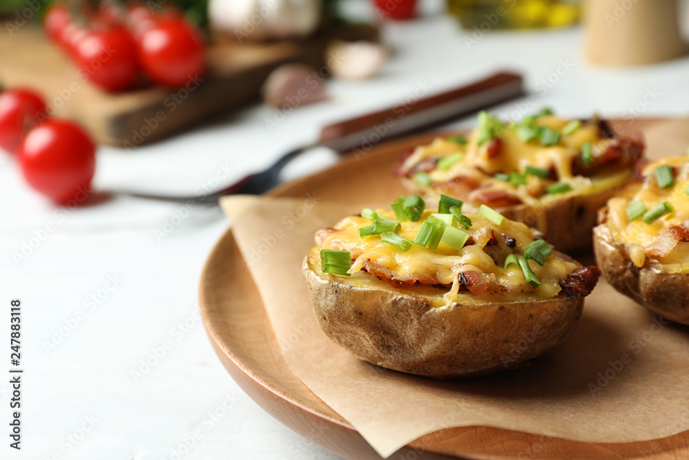 Plate of baked potatoes with cheese and bacon on table, closeup. Space for text Plate of baked potatoes with cheese and bacon on table, closeup. Space for text