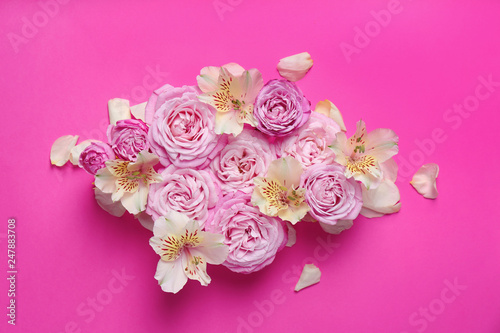 Fresh flowers on color background, top view