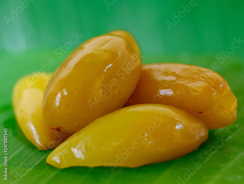 Pickled fruits or preserved sweet fruits in Thailand. Pickled Madun or Garcinia schomburgkiana Pierre fruit  photo