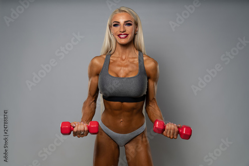 Leinwand Poster Woman Over White Background Biceps Exercise With Dumbbells