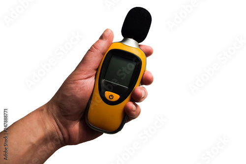 Isolated yellow sound meter holding in hand on white background. Commonly used in noise pollution studies, used for acoustic (sound that travels through air) measurements.