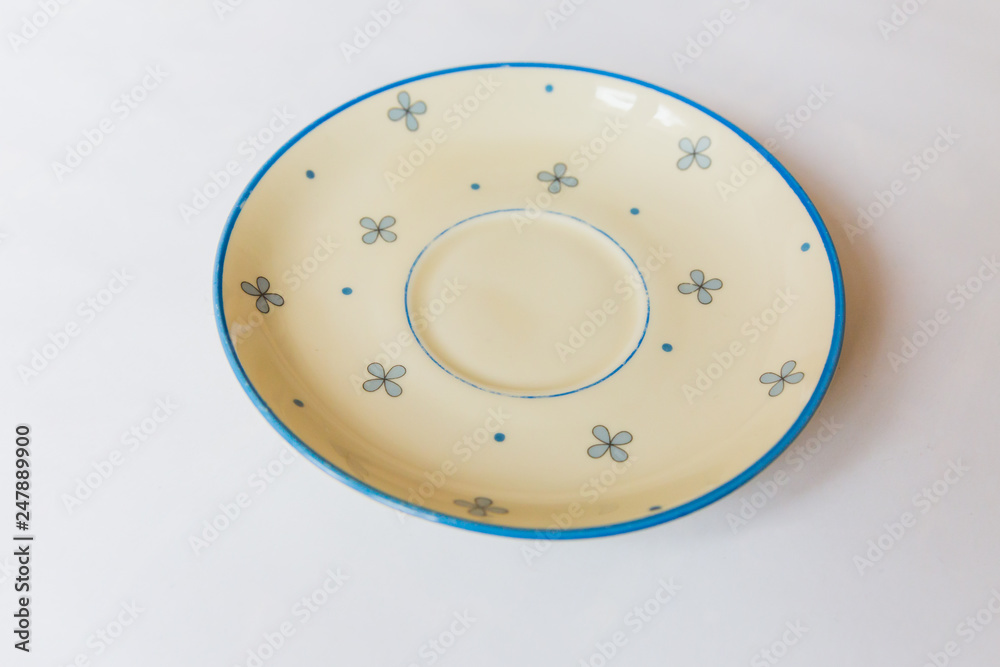 a yellow round plate with floral and line pattern on white background a yellow round plate with floral and line pattern on white background