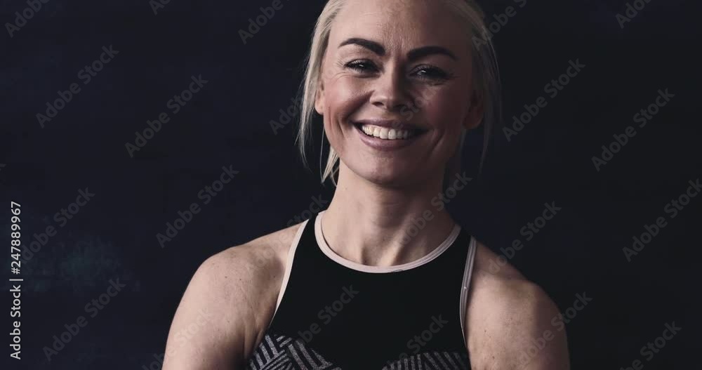 Young woman in sportswear smiling after a gym workout Young woman in sportswear smiling after a gym workout