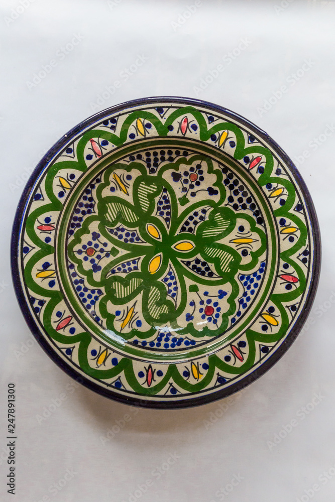 a white round plate with floral and line pattern on white background a white round plate with floral and line pattern on white background