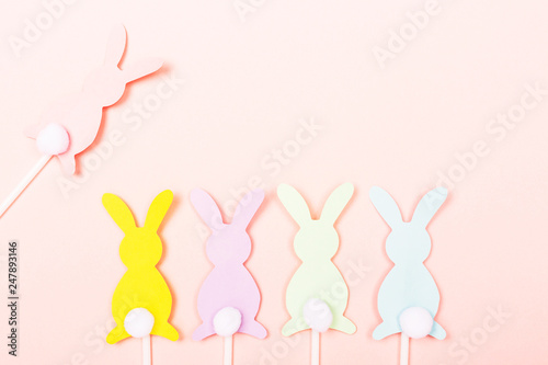 Easter bunnies on pastel pink background