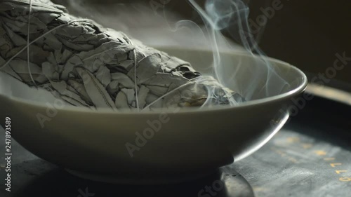 Ceremonial white sage burning in a bowl. photo