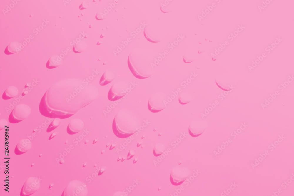 Water spill on Pink background