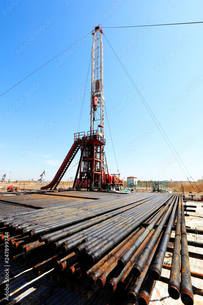 Oil drilling derrick and metal pipe