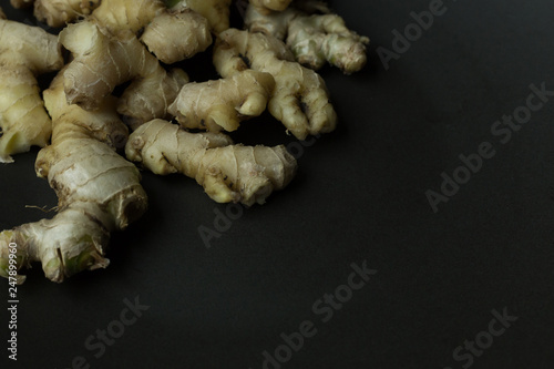 Ginger on black plate for food content.