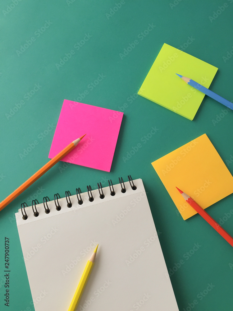 White blank notepad bright colorful rectangular post-it sticky notes  colored pencils on bright green paper color background Stock Photo | Adobe  Stock