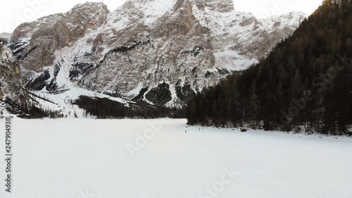 Aerial Drone View of Lago di Braies Mountain Lake in Winter photo