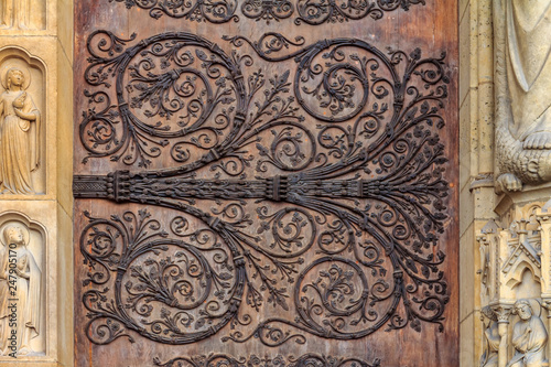 Intricate wrought iron vintage scroll work on the door hinges of Notre Dame de Paris Cathedral in Paris France forged metal hinges on the doors of Notre Dame de Paris Cathedral in Paris France